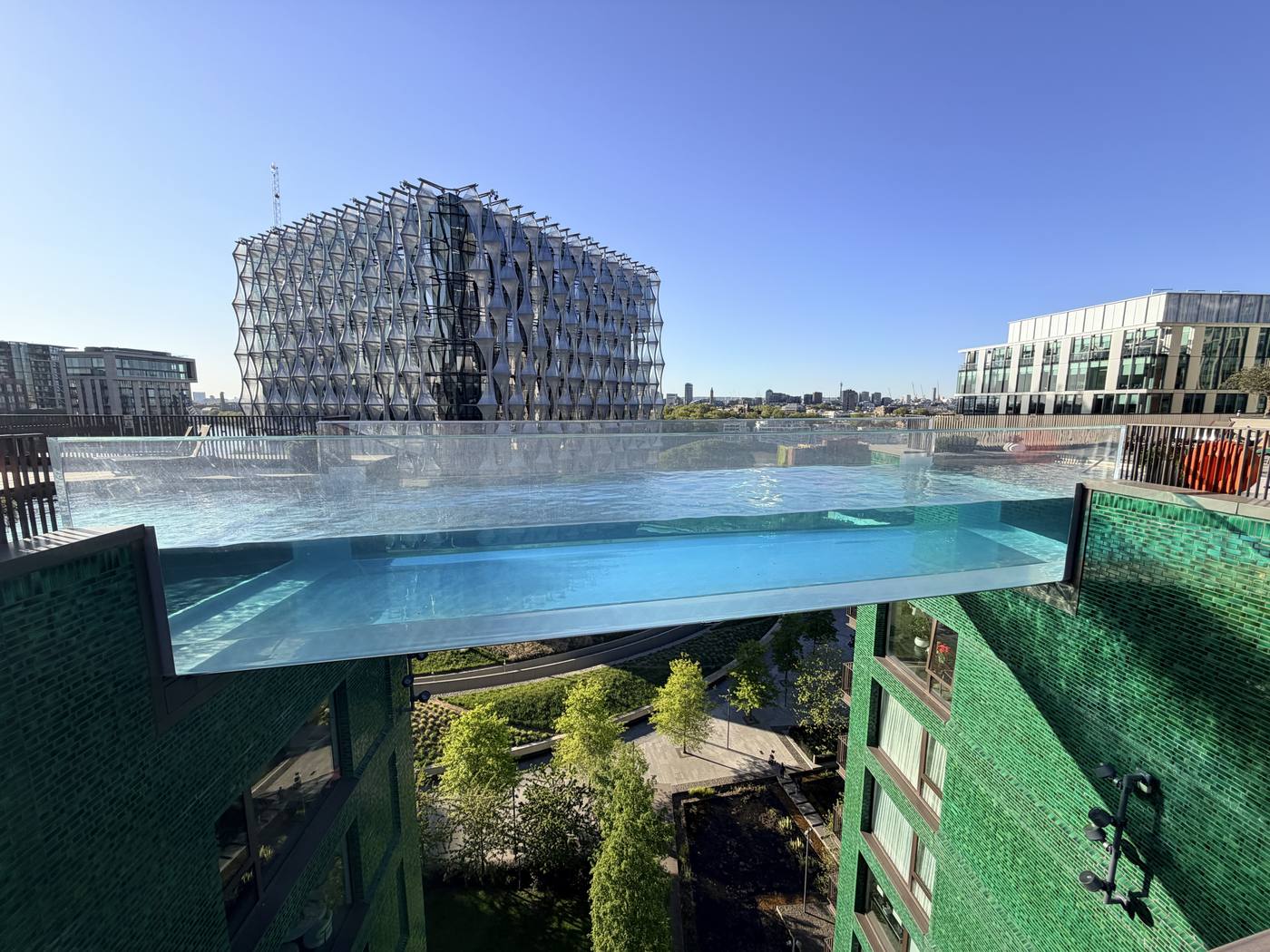 The glass Sky Pool seen from below, with the US Embassy behind it